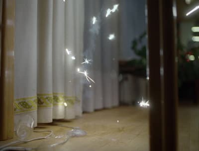 a window with a curtain and a string of lights on it
