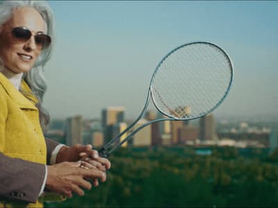 a woman holding a tennis racket in her hands