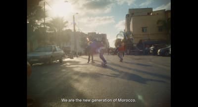 a group of people riding skateboards down a street