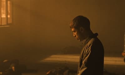 a man standing in a room with a window