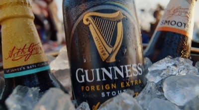 two bottles of beer sitting on top of ice