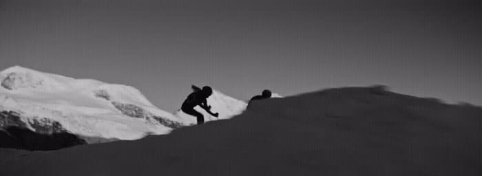 a black and white photo of a person on a snowboard