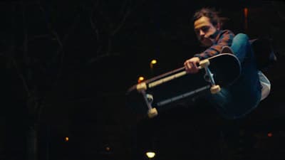 a man doing a trick on a skateboard in the air
