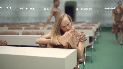 a woman sitting at a table in a room