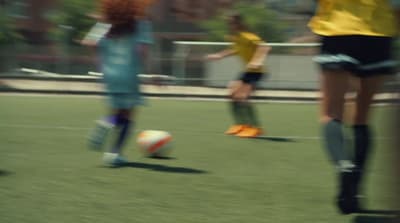 a blurry photo of two girls playing soccer