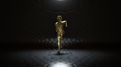 a golden man standing in a dark room