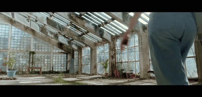 a person standing in a room with lots of windows