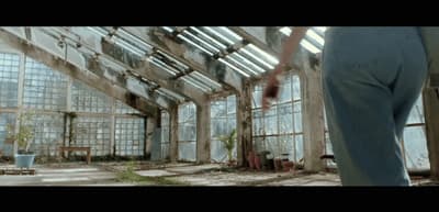 a person standing in a room with lots of windows