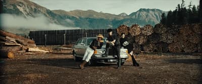 a group of people standing next to a car
