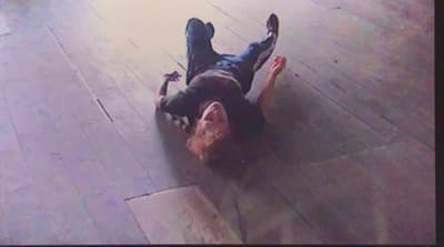 a man laying on the ground on his stomach