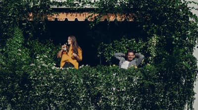 a couple of people that are sitting in a window