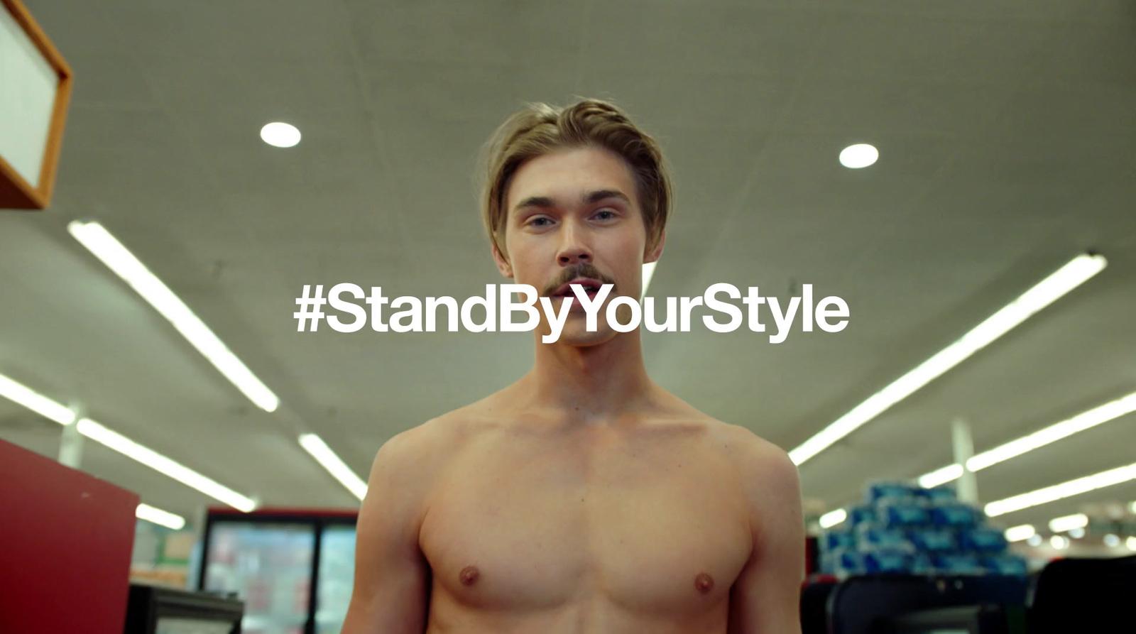 a man with no shirt standing in a store