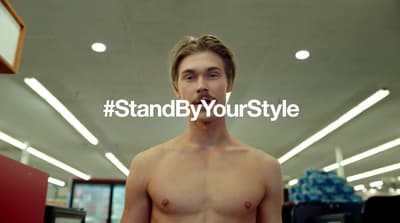 a man with no shirt standing in a store