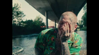 a man with his hands on his face