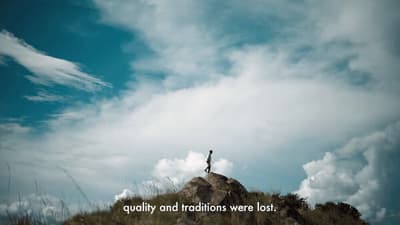 a person standing on top of a hill with a sky background