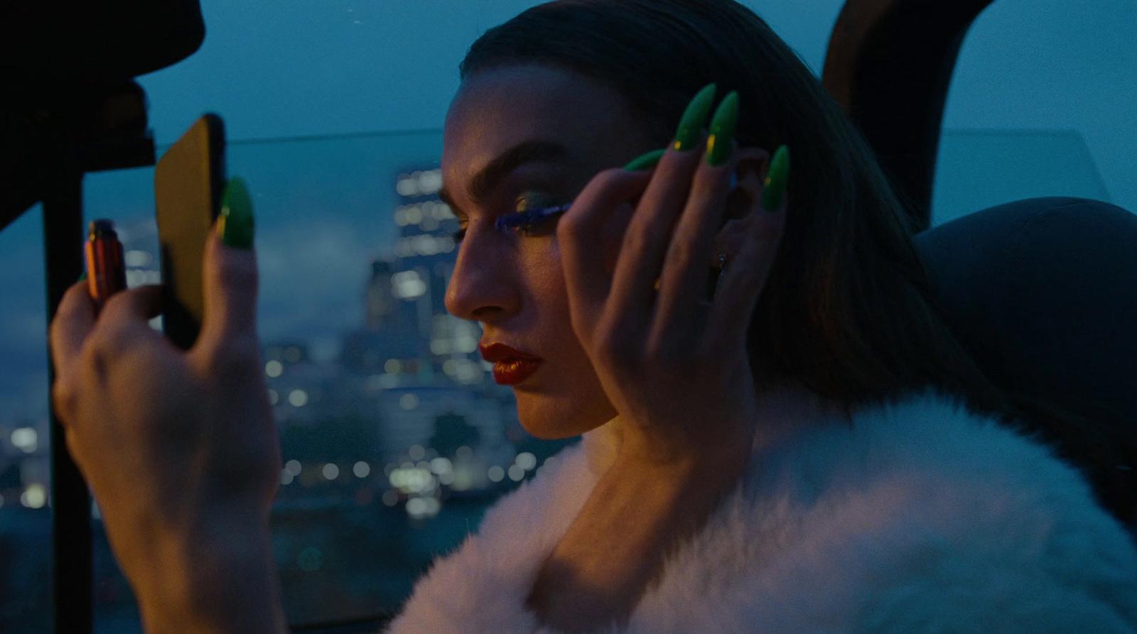 a woman sitting in a car holding a cell phone