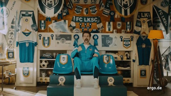 a man sitting on top of a chair in a room