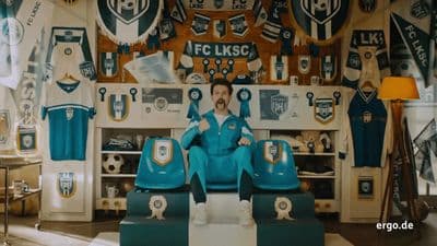 a man sitting on top of a chair in a room
