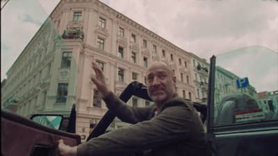 a man waving from the back of a truck