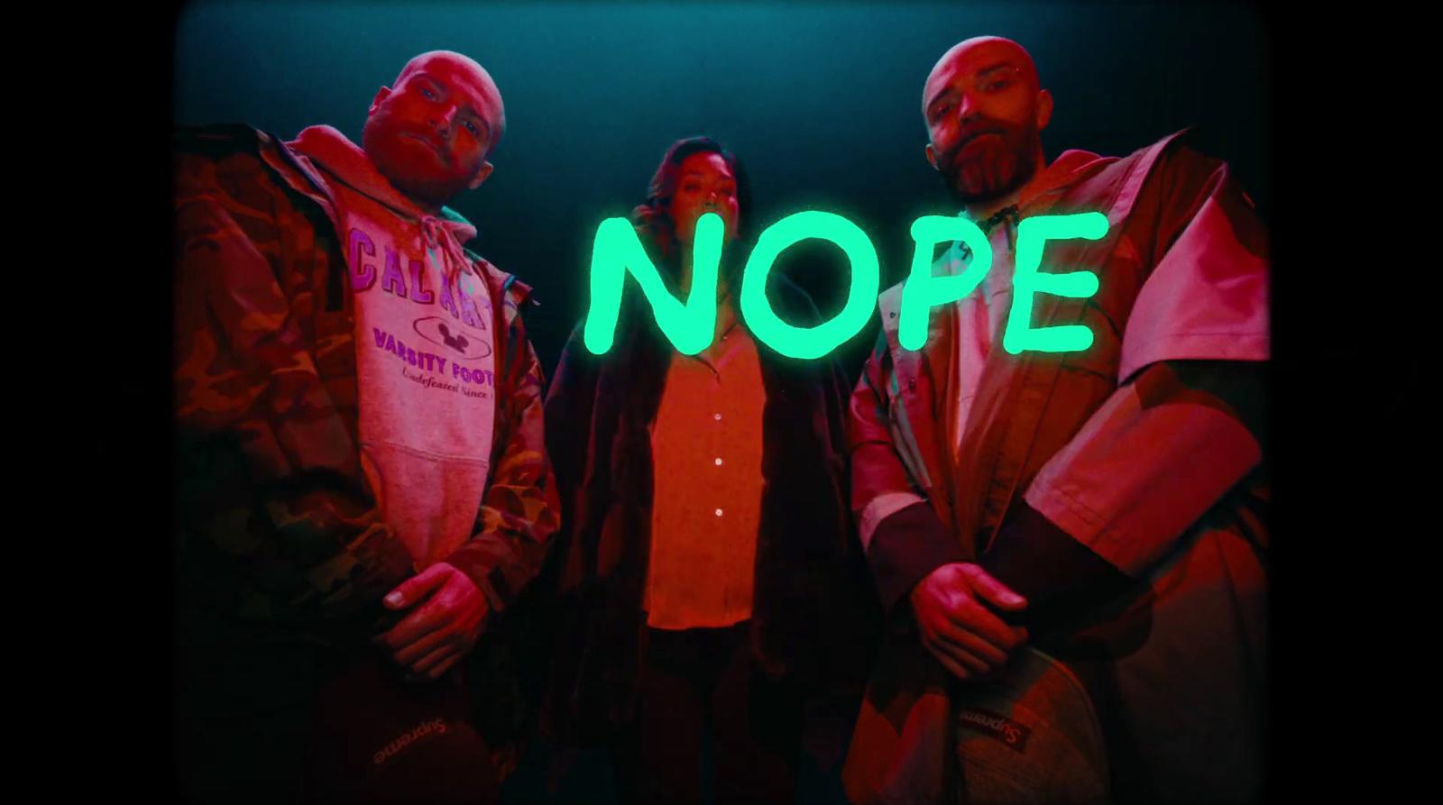 a group of people standing in front of a neon sign