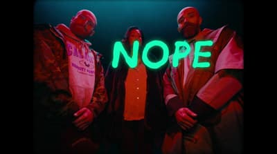 a group of people standing in front of a neon sign