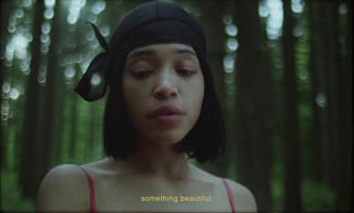 a woman wearing a black hat in a forest