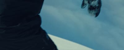 a man flying through the air while riding a snowboard