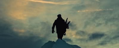 a man standing on top of a snow covered mountain
