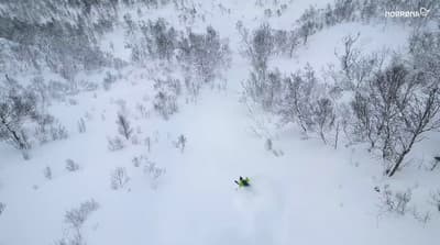 a person riding skis down a snow covered slope