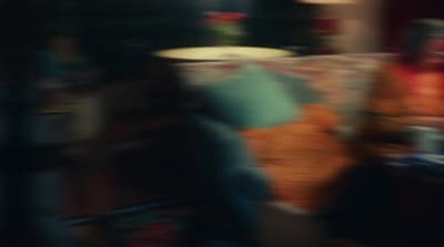 a blurry photo of a person sitting at a table