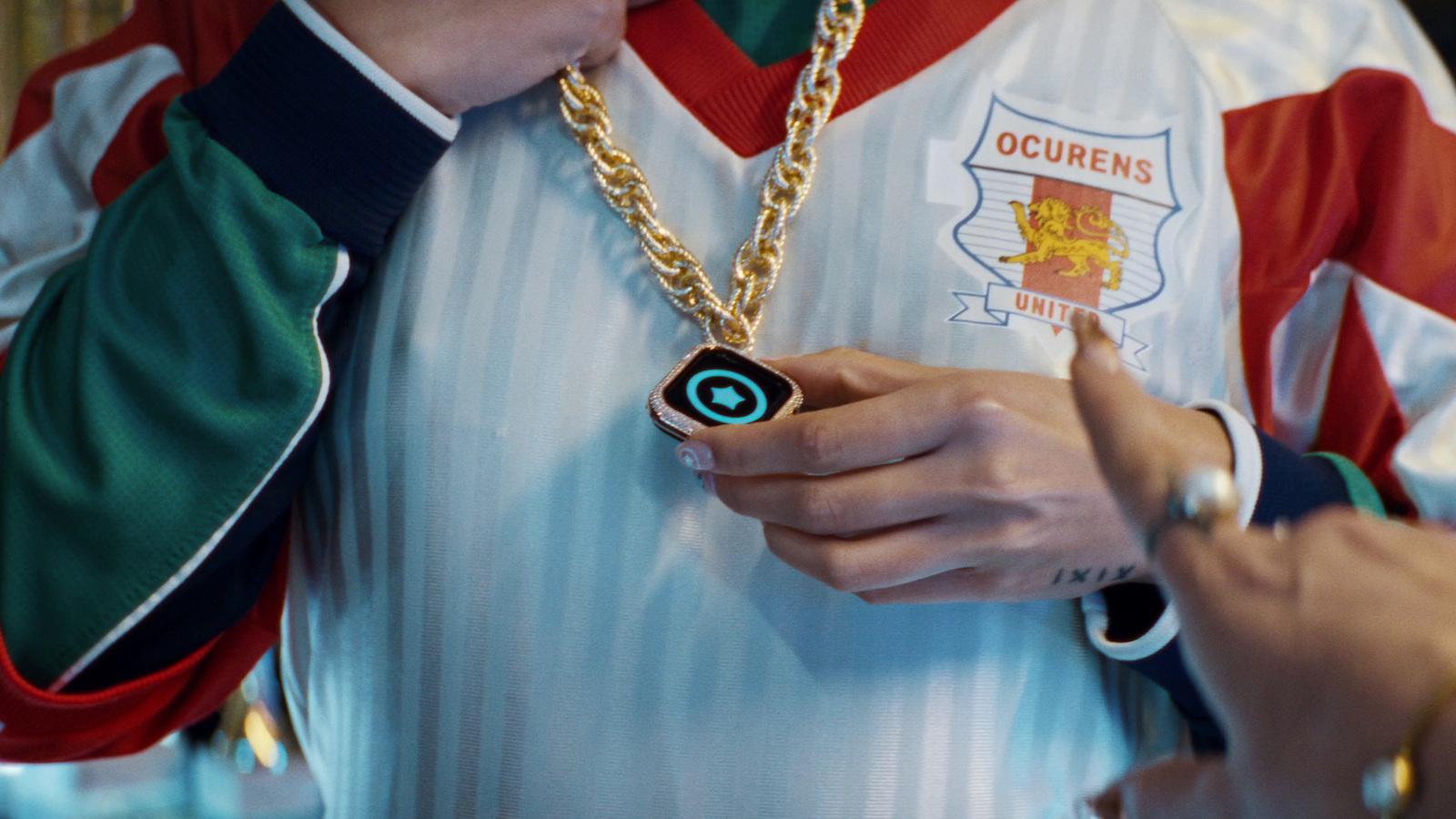 a person wearing a necklace with a camera attached to it