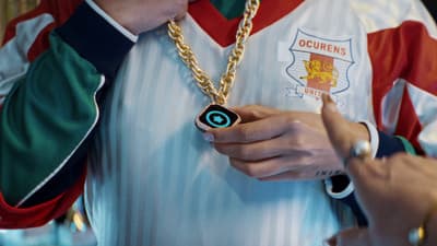 a person wearing a necklace with a camera attached to it