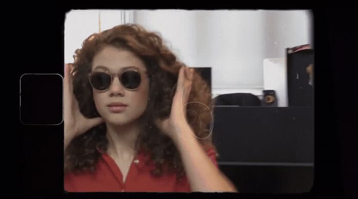 a woman in a red shirt and black sunglasses