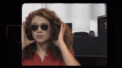 a woman in a red shirt and black sunglasses