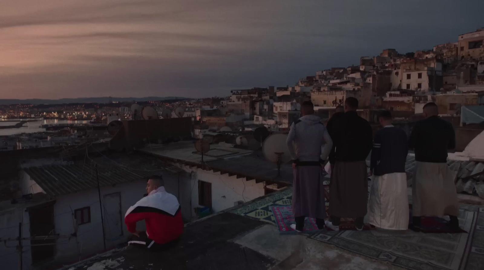 a group of people standing on top of a roof