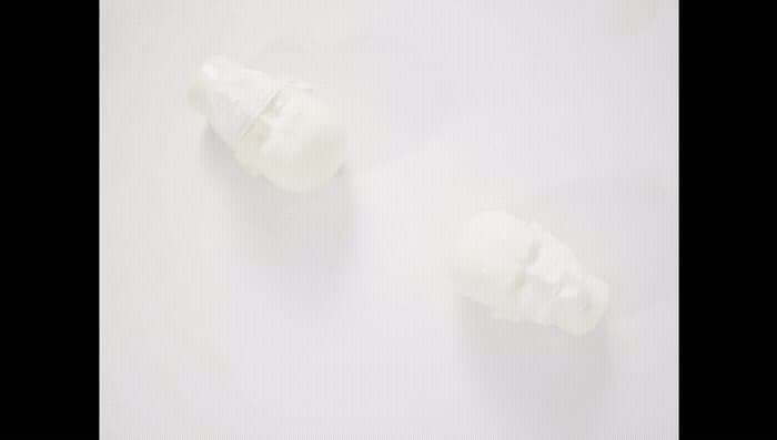 a couple of pieces of white plastic sitting on top of a table