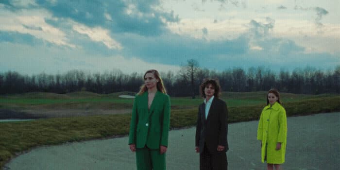 a group of three people standing next to each other