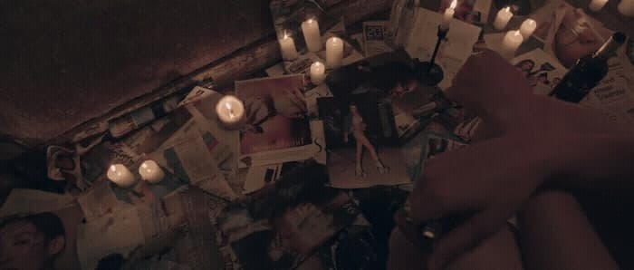 a group of people holding candles in front of a wall