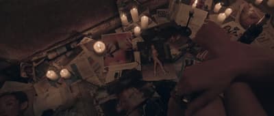a group of people holding candles in front of a wall