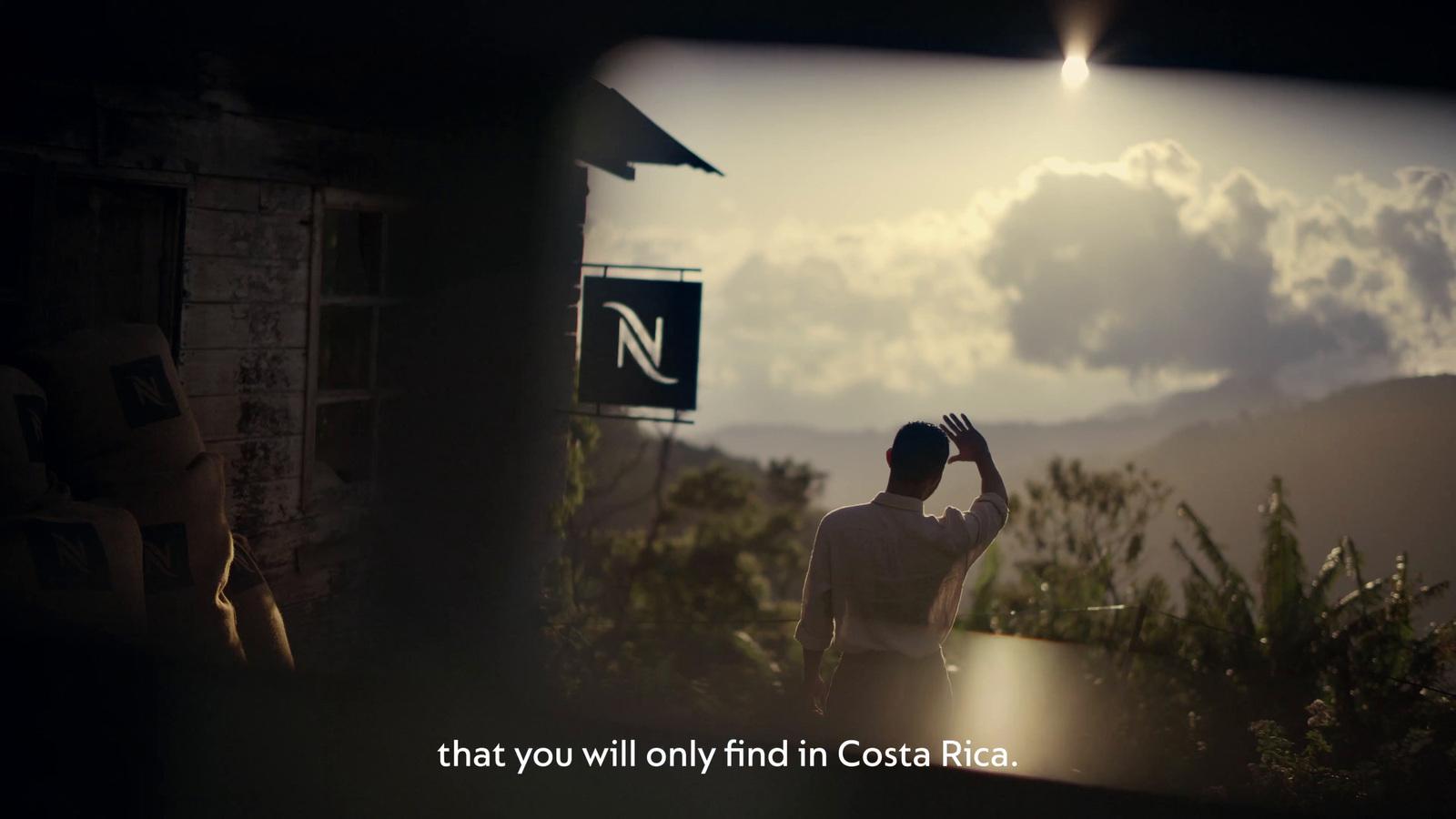 a man standing in front of a sign with a sky background