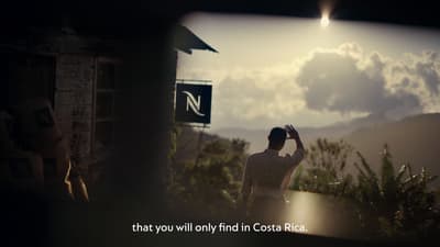 a man standing in front of a sign with a sky background