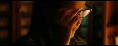 a man with glasses is looking at something