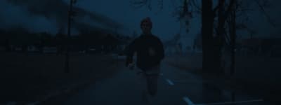 a man walking down a street at night