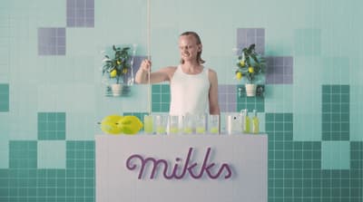 a man standing in front of a display of drinks