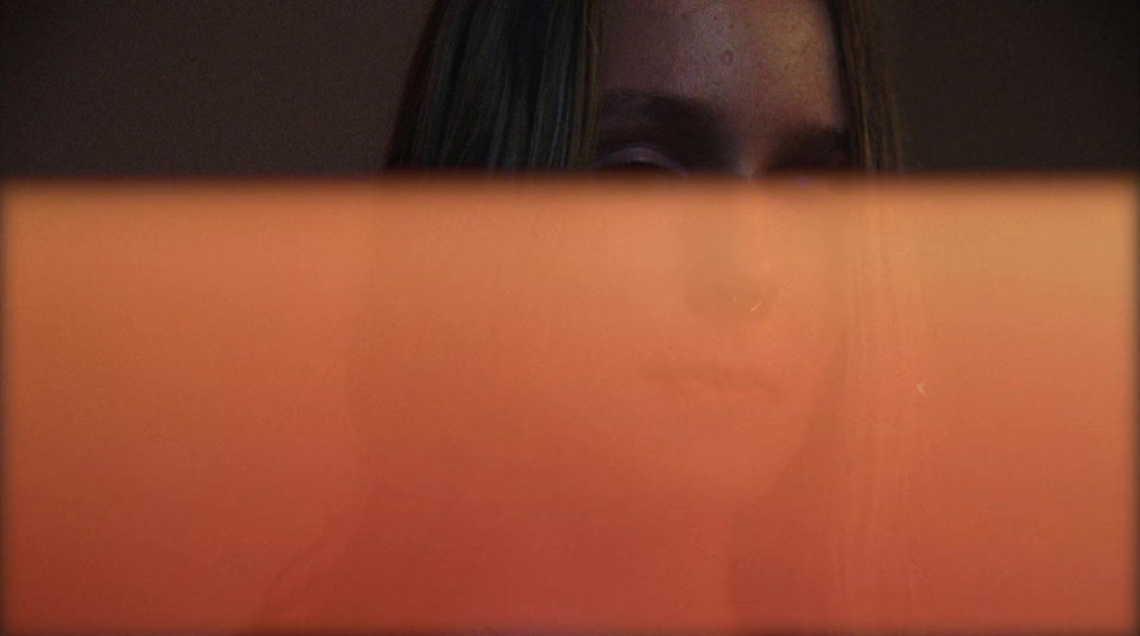 a woman looking at a laptop screen with a blurry background