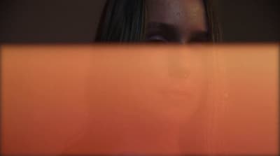 a woman looking at a laptop screen with a blurry background