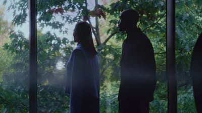 a man and a woman standing in front of a window