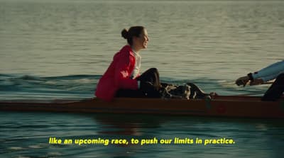 a man and a woman sitting on a boat in the water