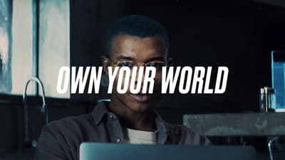 a man wearing glasses looking at a laptop