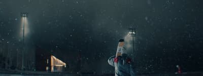a person holding a baseball bat in the rain
